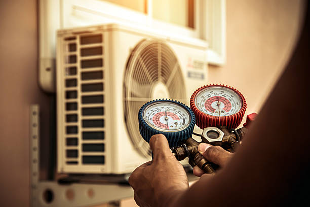 Professional Air Conditioning Service technician working in Sterling, KS